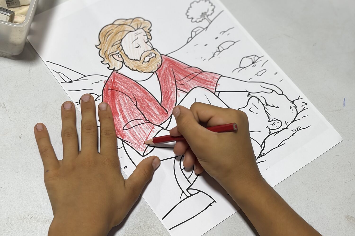 A child at a church in Turkey coloring the Good Samaritan from a Selah Seed lesson